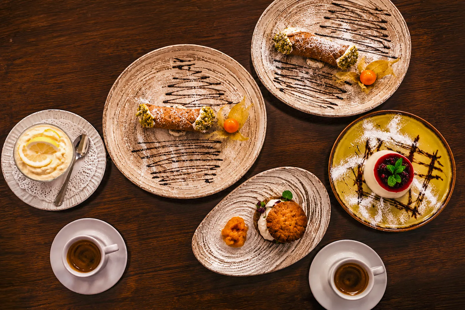 Selection of authentic Italian desserts with cannoli, cheesecake, lemon mousse and espresso at Little Italy in York