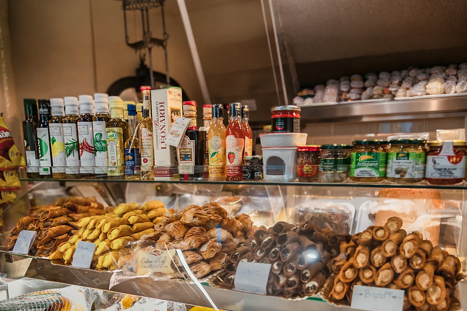 Traditional Italian deli counter with artisan cheeses, cured meats, pastries and imported Italian products at Little Italy York