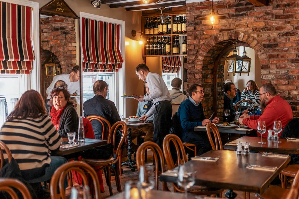 Guests dining inside Little Italy restaurant in York with friendly table service and authentic Italian atmosphere