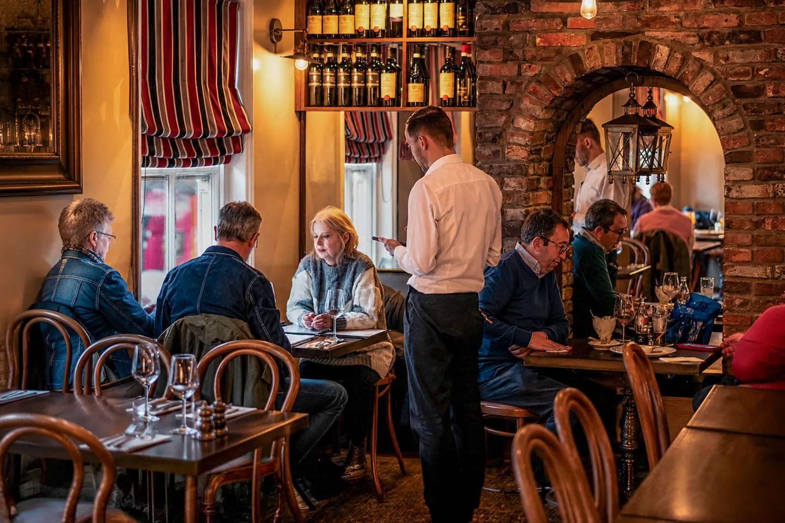 Guests enjoying authentic Italian dining with attentive table service at Little Italy restaurant in York