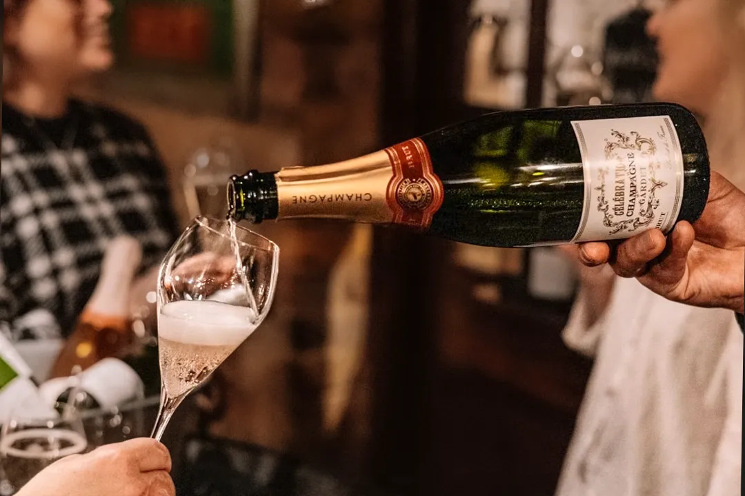 Champagne being poured into a glass during table service at Little Italy in York