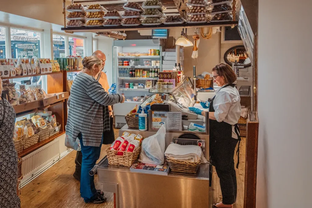 Customers shopping inside Little Italy Italian deli on Goodramgate in York city centre