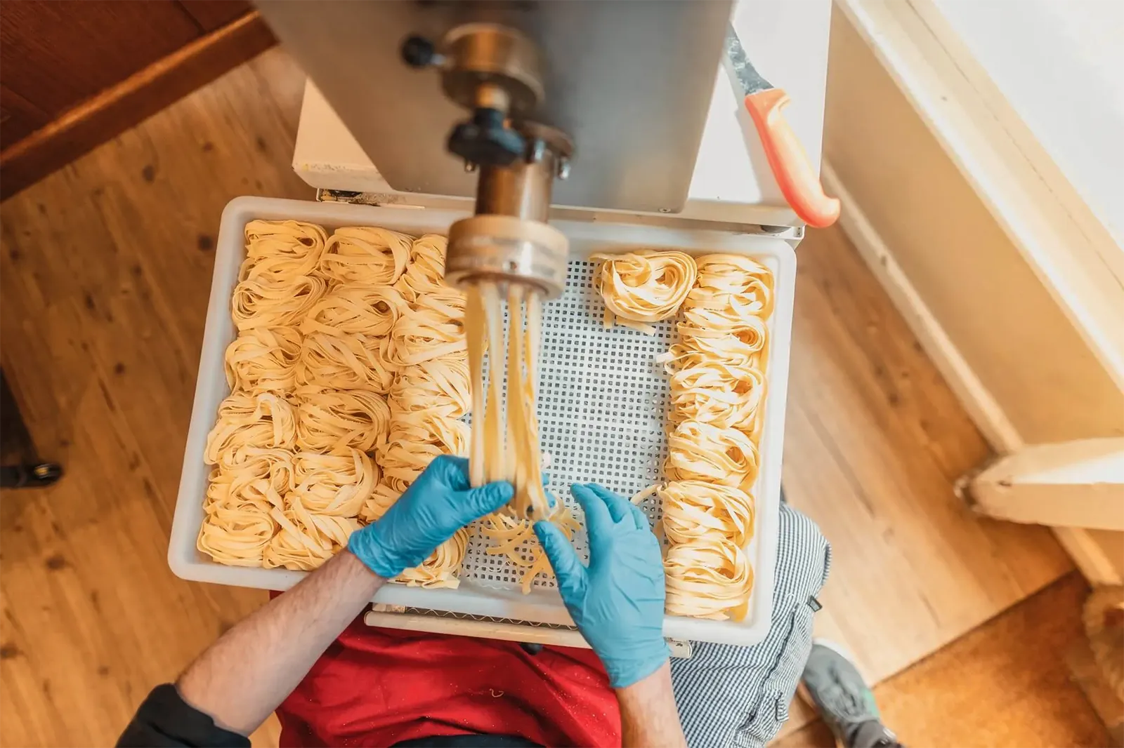 Chef making fresh homemade tagliatelle pasta at Little Italy Italian restaurant and deli in York