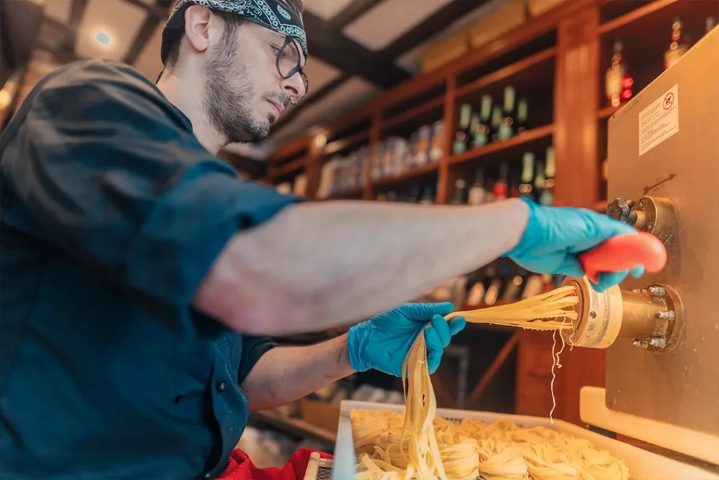 Italian chef making fresh homemade tagliatelle at Little Italy restaurant in York
