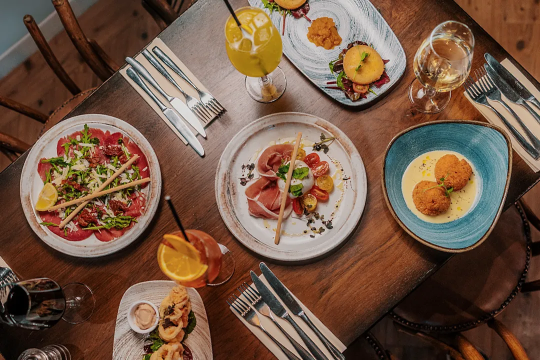 Overhead view of Italian starters, cocktails and wine served at Little Italy in York