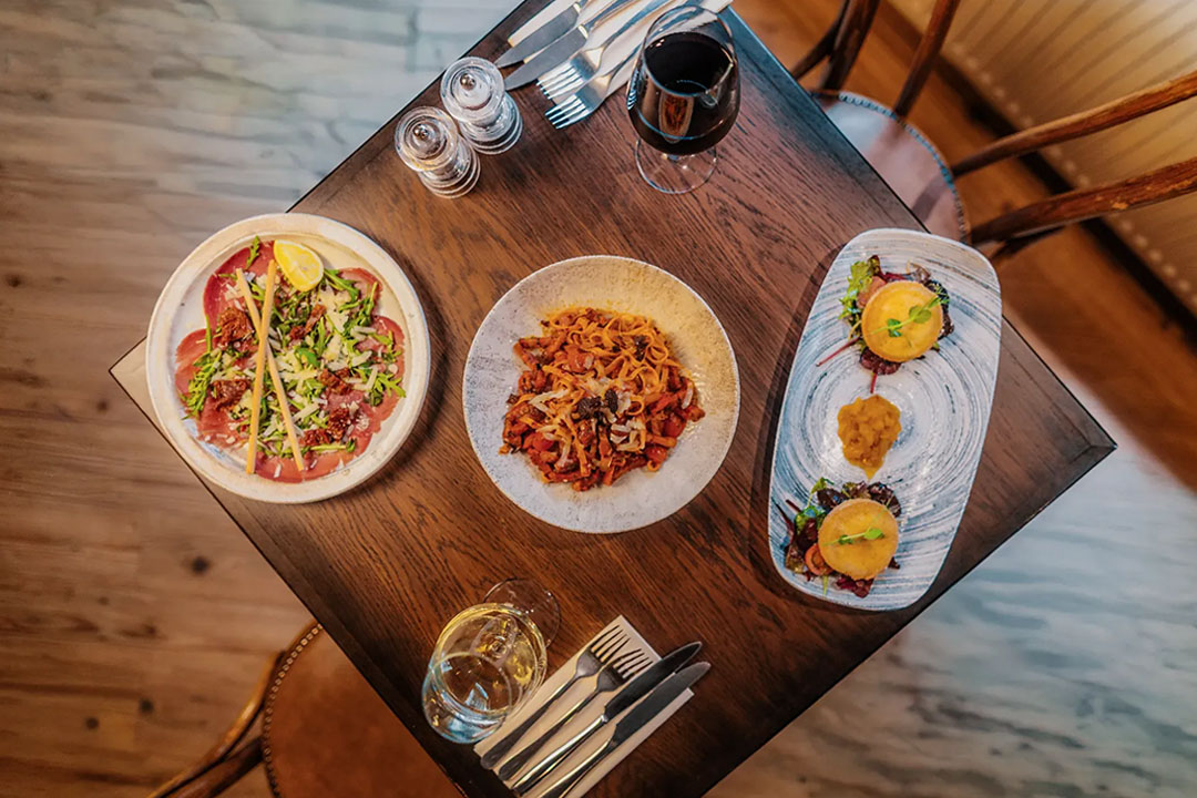 Overhead view of authentic Italian starters, homemade pasta and wine served at Little Italy in York