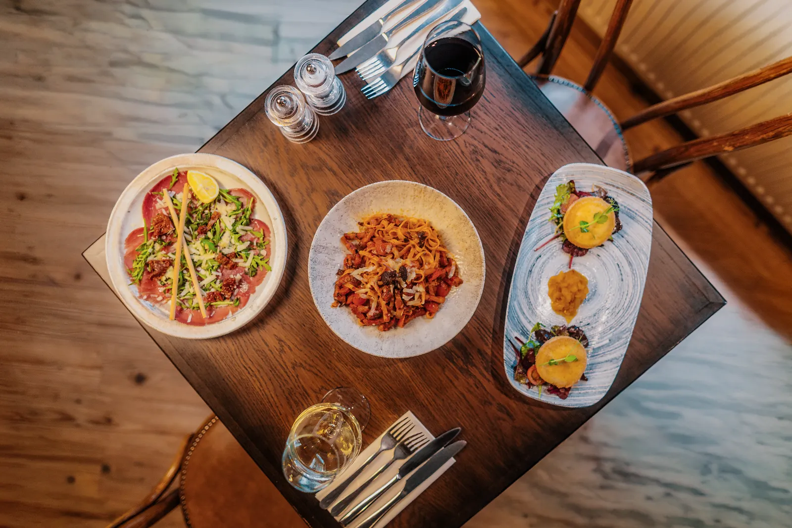 Overhead view of authentic Italian starters, homemade pasta and wine served at Little Italy in York