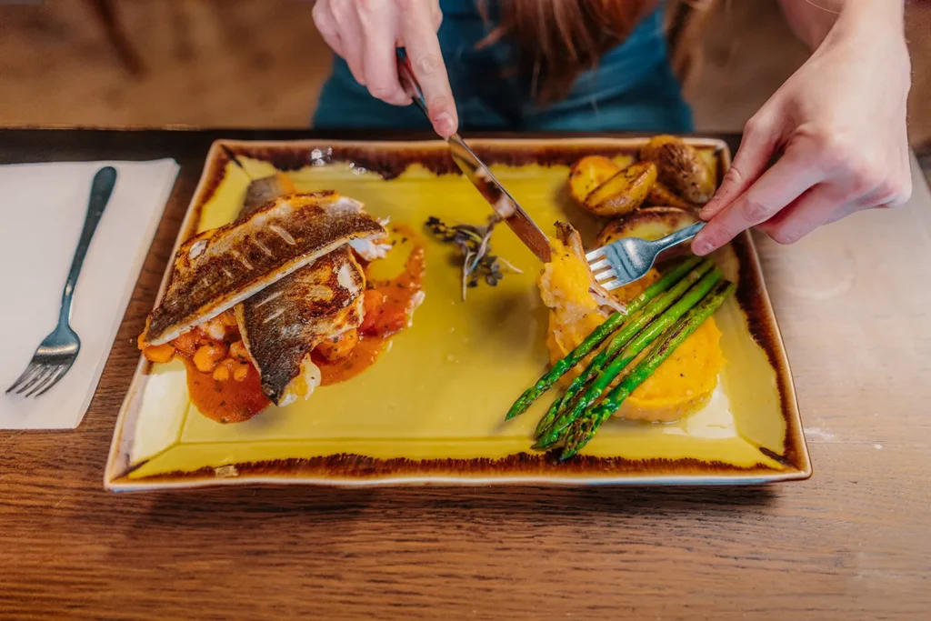 Pan fried sea bass served with roasted potatoes, asparagus and Mediterranean vegetables at Little Italy in York