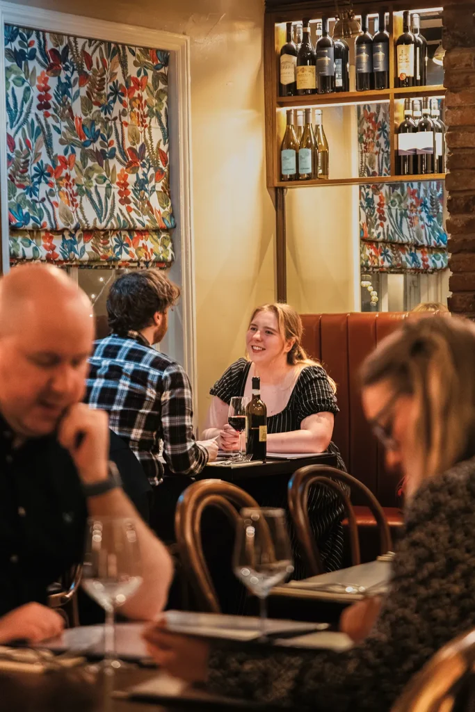 Guests enjoying dinner and Italian wine at Little Italy restaurant in York city centre